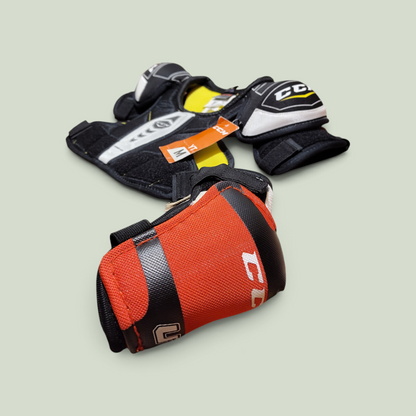 Rörelseboxen youth hockey elbow pads in red, black, and white with adjustable straps and protective padding